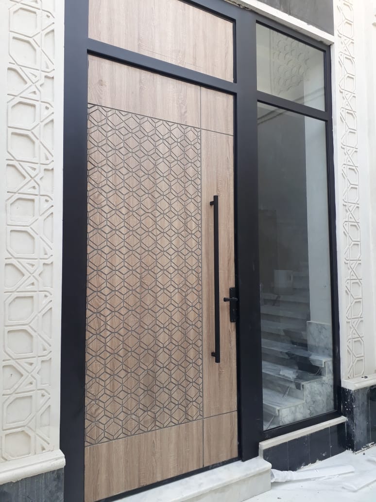 Steel entry door with laser-cut panel and glazed sidelight
